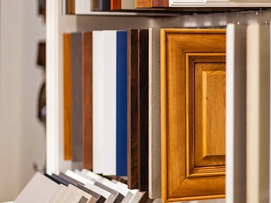 Hanging rack of cabinet door samples in natural wood, navy, espresso and painted finishes at the Tabinets showroom