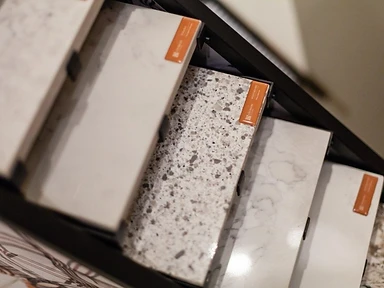 Countertop material samples in white quartz, terrazzo and marble finishes available through Tabinets near Lakeville, MA