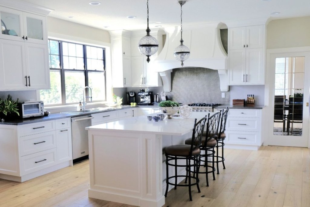 Custom luxury kitchen with white shaker cabinetry and a large island, designed by Tabinets near Middleborough, MA
