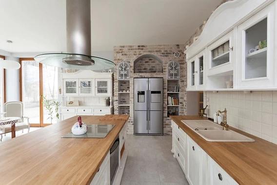 A Tabinets kitchen designer reviewing cabinet samples and 3D renderings with a homeowner