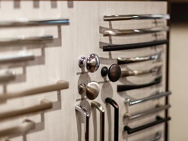 Richelieu hardware display board showing cabinet knobs and bar pulls in chrome, brushed nickel and matte black finishes at the Tabinets showroom