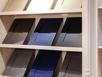 Display of nine cabinet door samples in a 3x3 grid showing various finishes and colors available at the Tabinets showroom